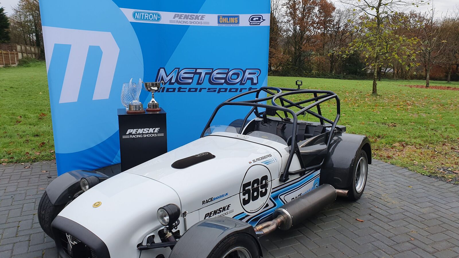 Simon Rogers' championship-winning Caterham 7 race car with championship trophies